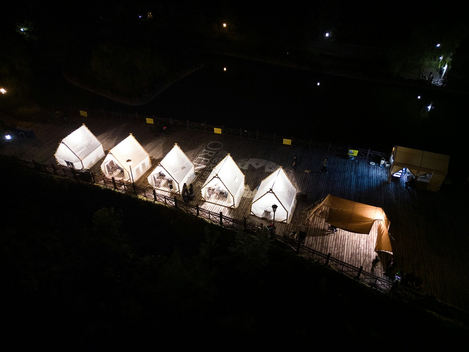 a group of tents lit up at night
